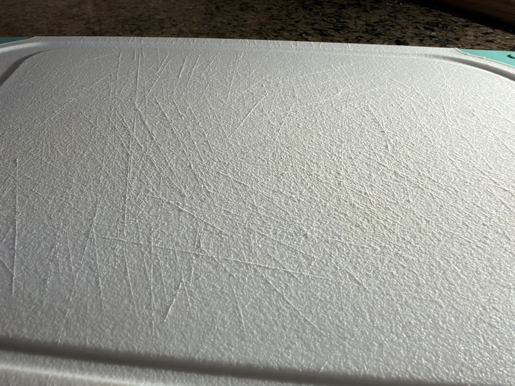 Scratched, stained plastic cutting board