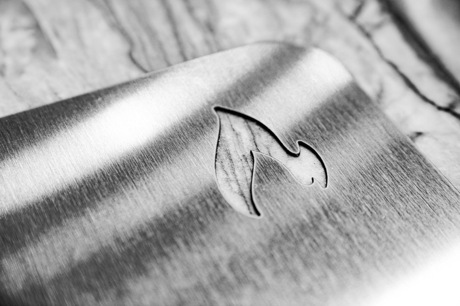 Macro photo of the flame logo water-jet cut clean through solid brushed stainless steel